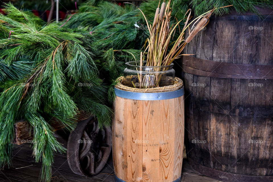 Christmas pine branches on a vintage wagon next to a wooden barrel