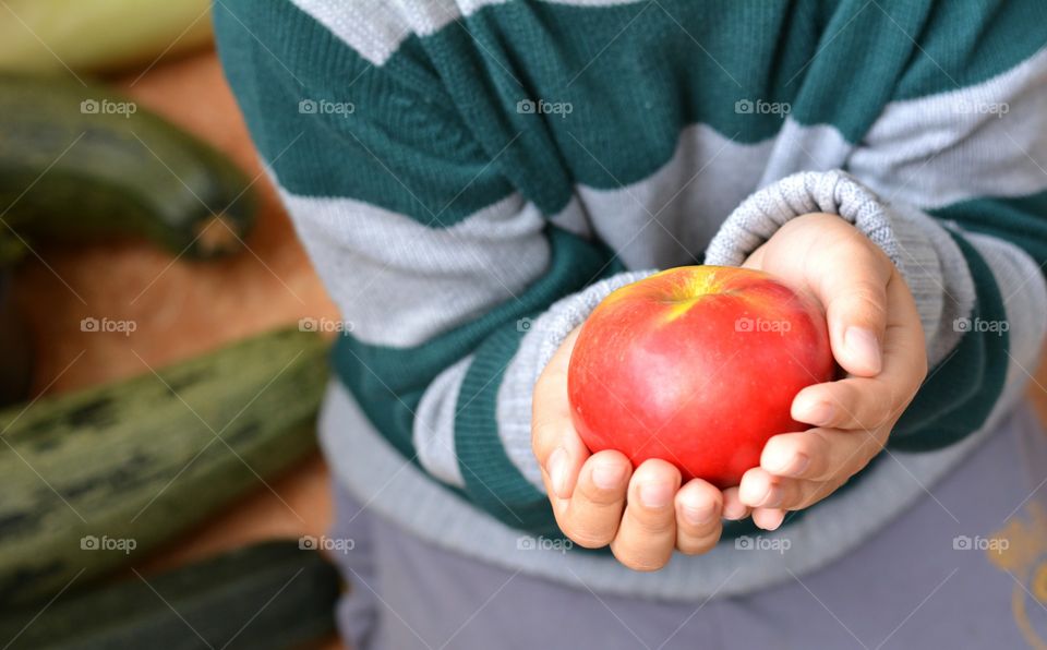 red apple fruit in the hand child