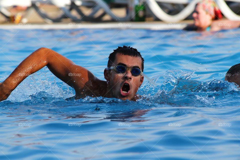 Young man swimming in pool