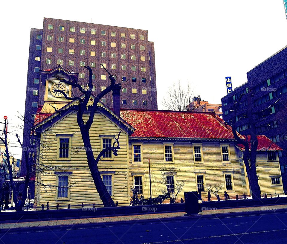 ghost old house in the middle of a modern city