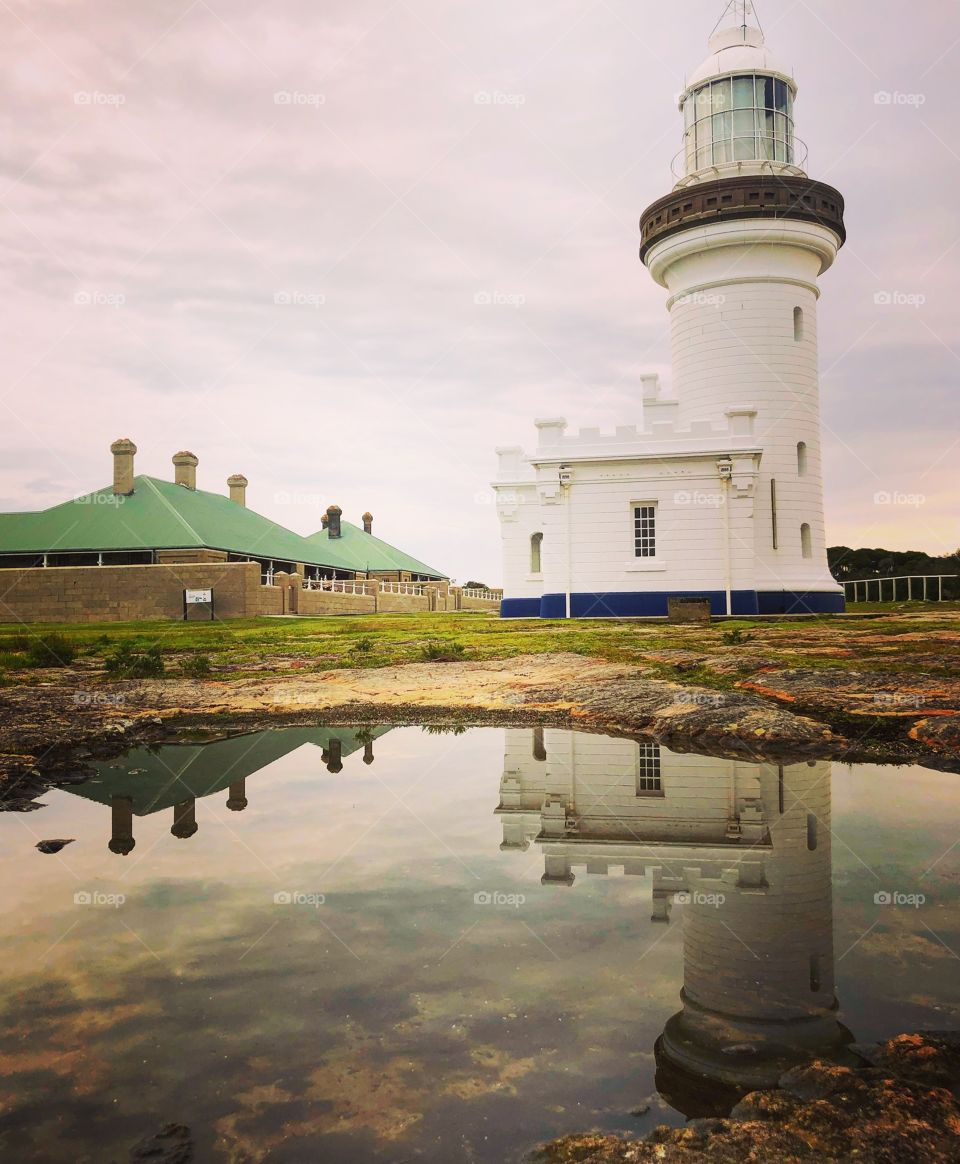 Point perpendicular lighthouse with reflections in the water 