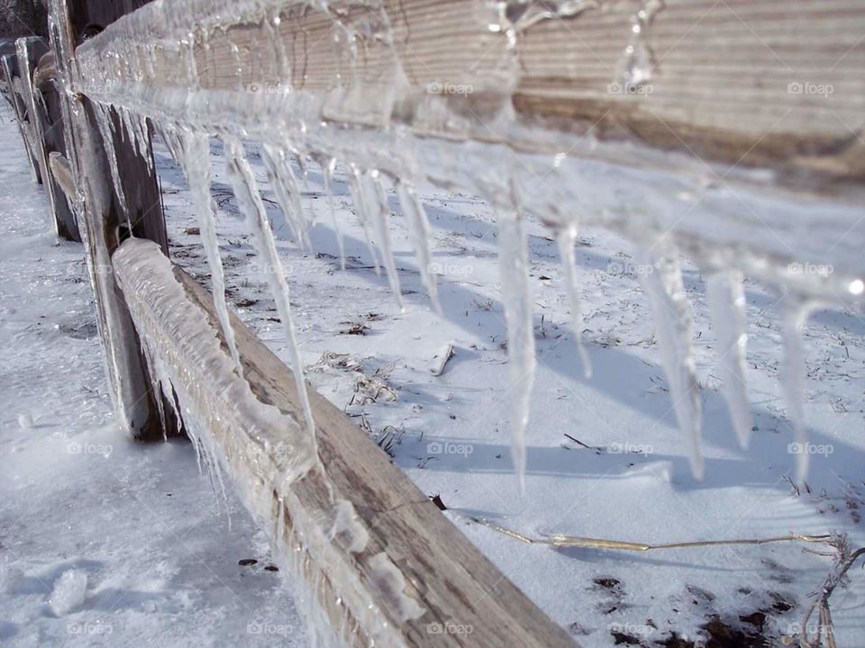 icy fence. freezing rain made icicles