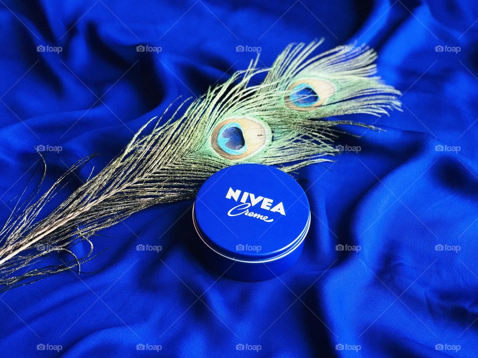 Nivea peacock feathers with blue background.