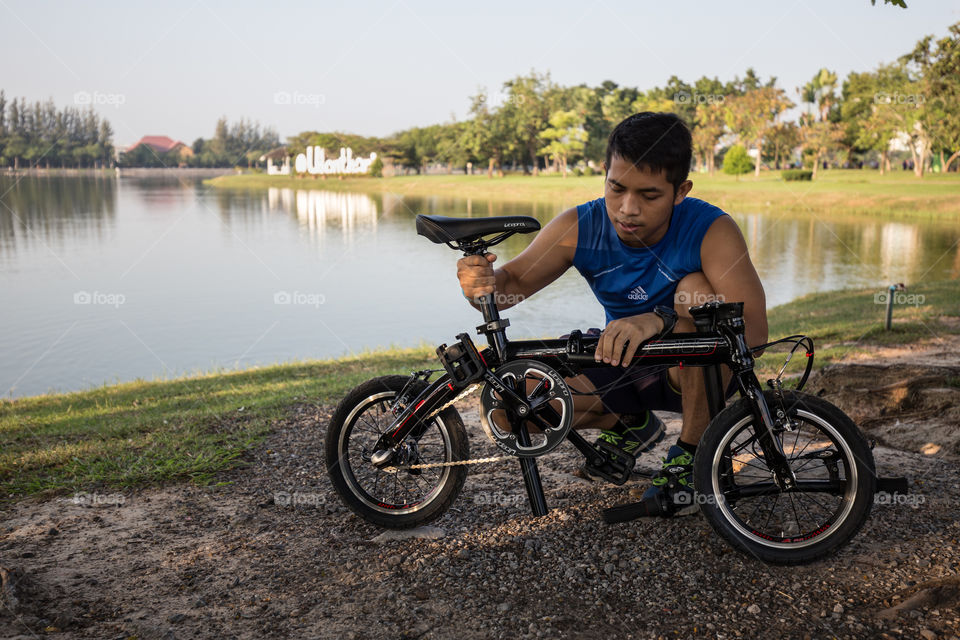 Man fixing bike in the park 