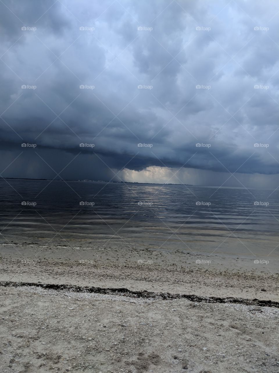 ominous clouds show one little area with good weather... look out! This is looking towards Ft Myers from the Sanibel Island causeway, Sanibel, FL.