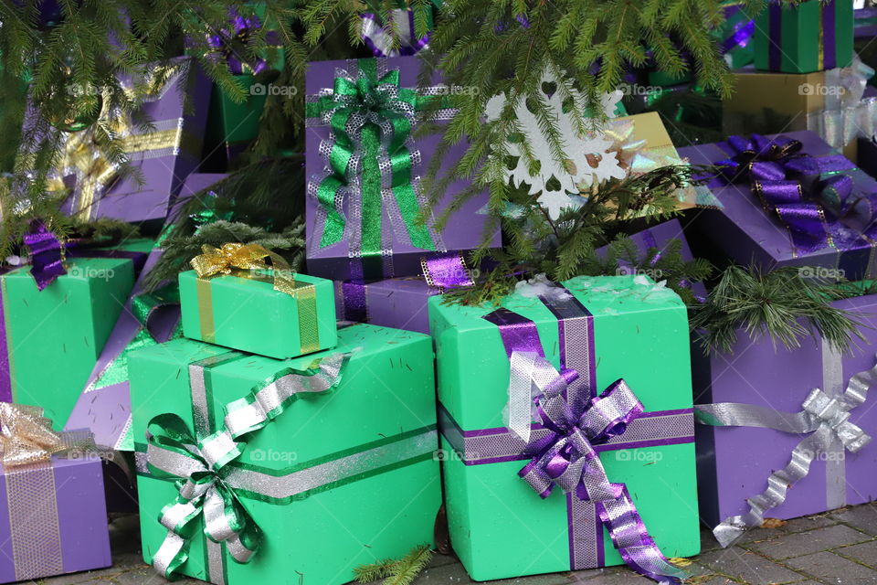 Gifts a boxes nicely wrapped  and arranged under the tree in Christmas time