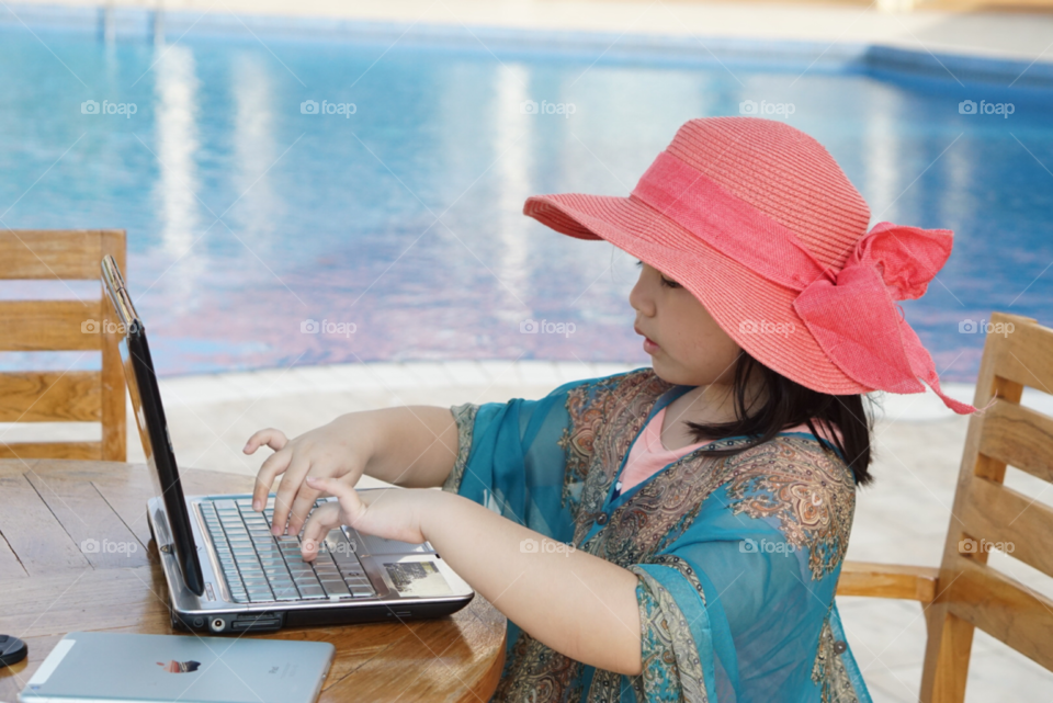 cute and stylist little girl using technology
