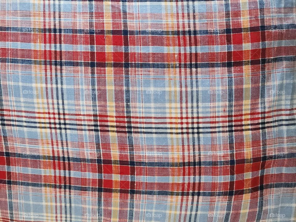 red blue white yellow black plaid pattern fabric textile close-up