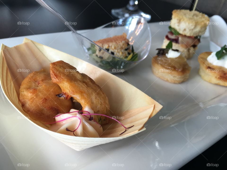 French Cuisine croquettes mini crab cakes in bamboo serving tray with infused crème fraîche and hors d'œuvres 