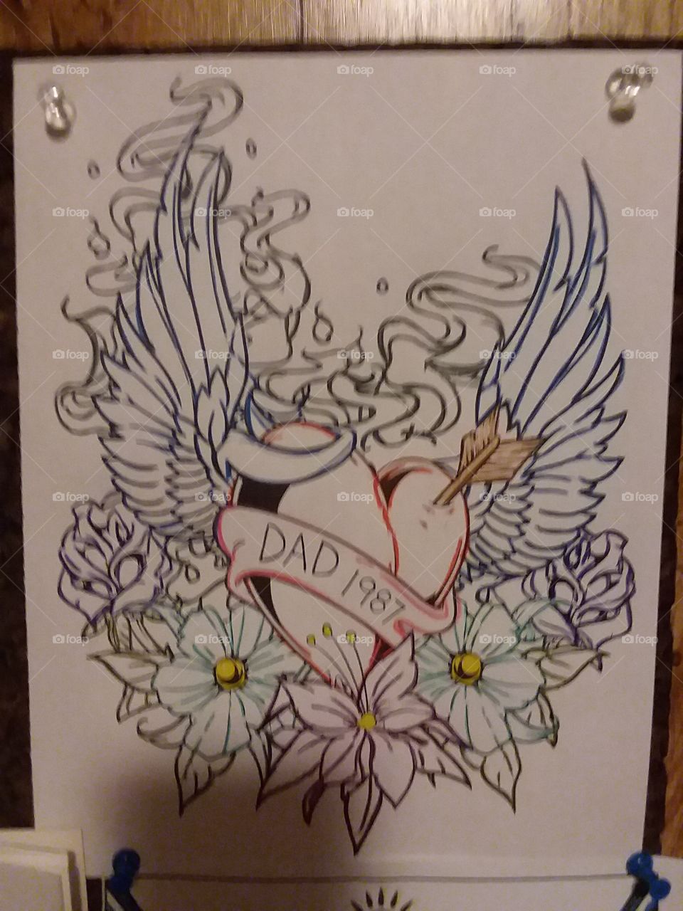 This is a design that would represent the memory of my dad. The heart & wings are him in my mind, the flowers are the beauty of his life.