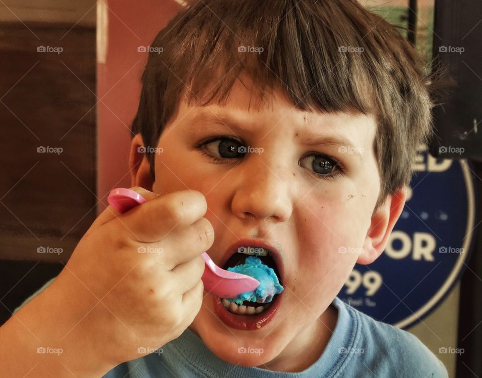 Little Boy Eating A Snack
