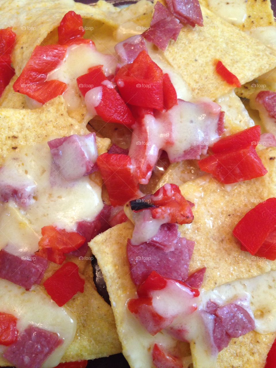 Close up nachos tortilla cheese peppers onion Mexican 