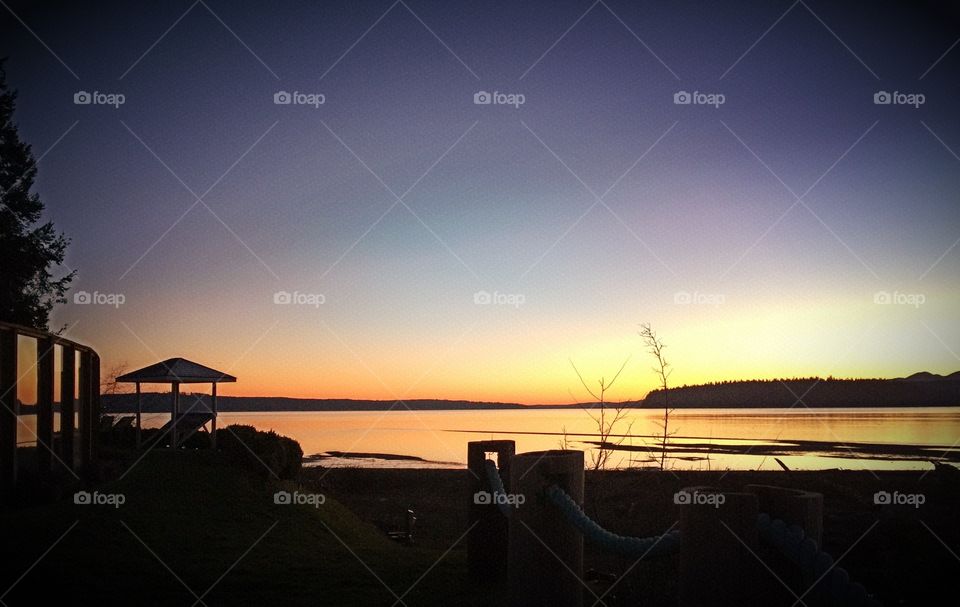 Railing at beach during sunset