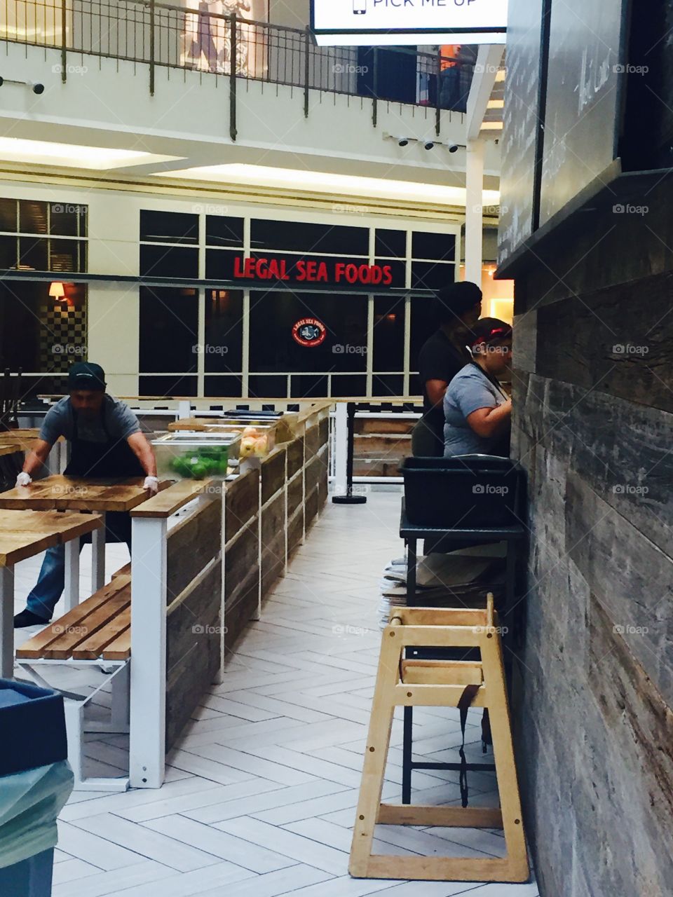 Workers setting up tables for opening restaraunt  