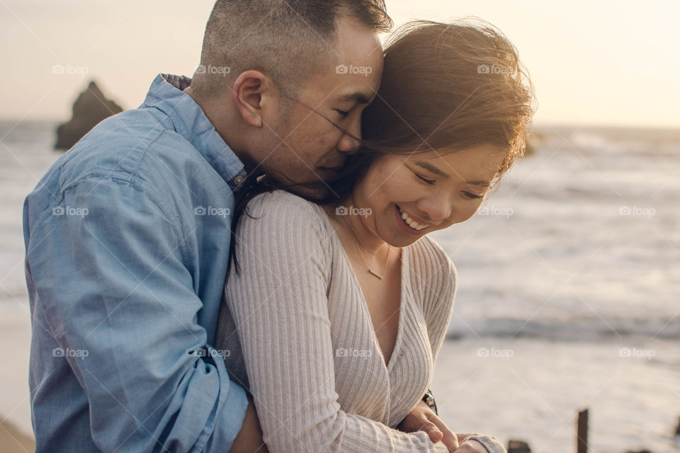Hugging and smiling at the beach