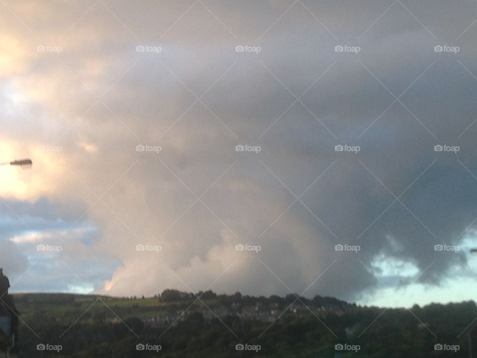 Cloud sitting on a hilltop