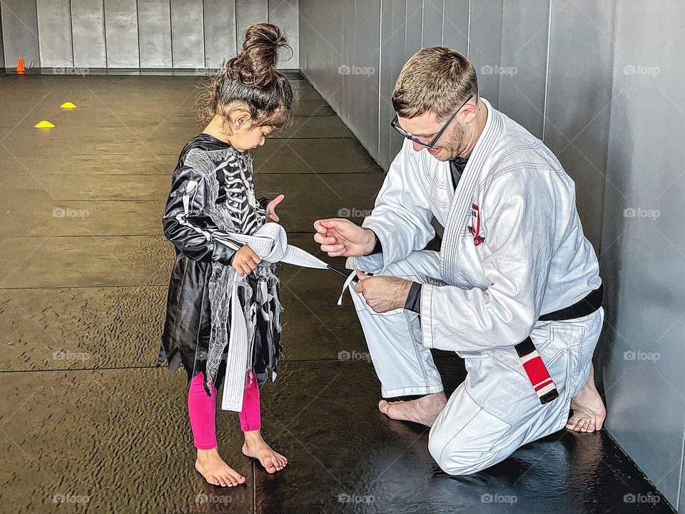 Little girl gets Jiu Jitsu belt stripe, stripe ceremony for kid’s Martial Arts class, Jiu Jitsu class for kids 