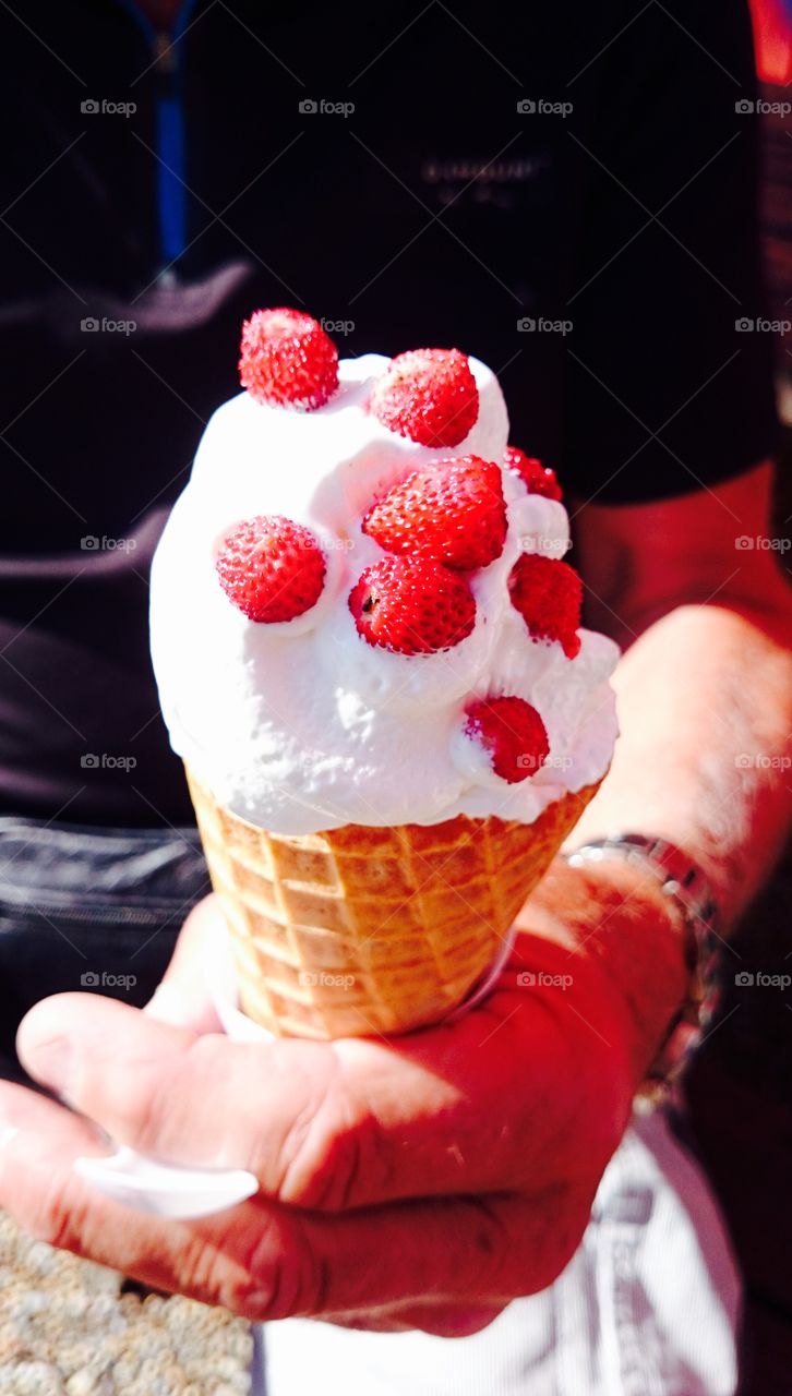 A person holding Ice cream cone