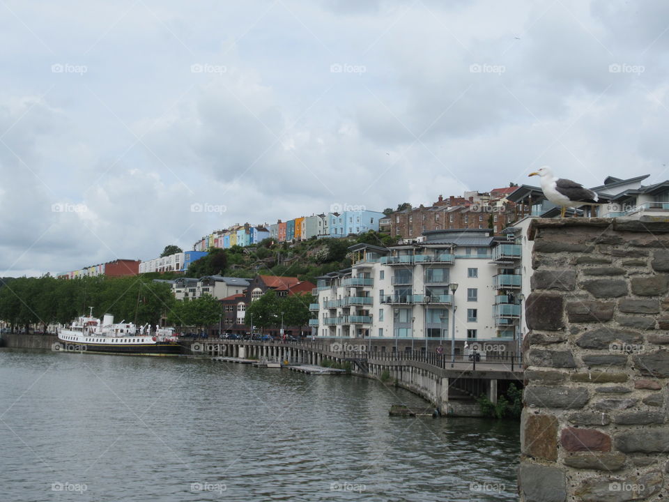 Overlooking Bristol docks with colourful houses on the hill