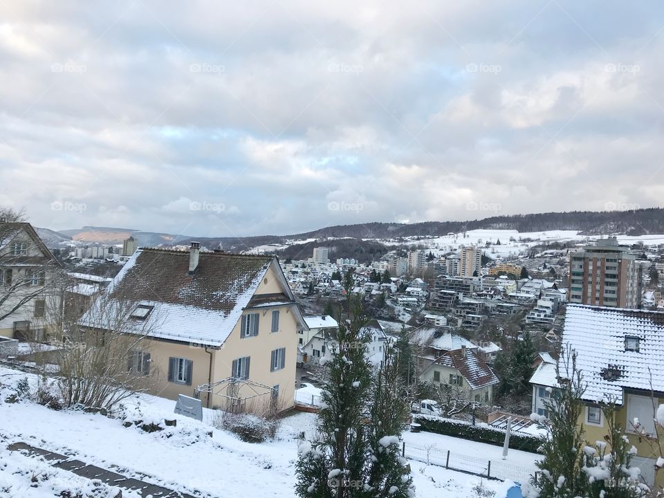 Snow covered houses and trees in Switzerland 