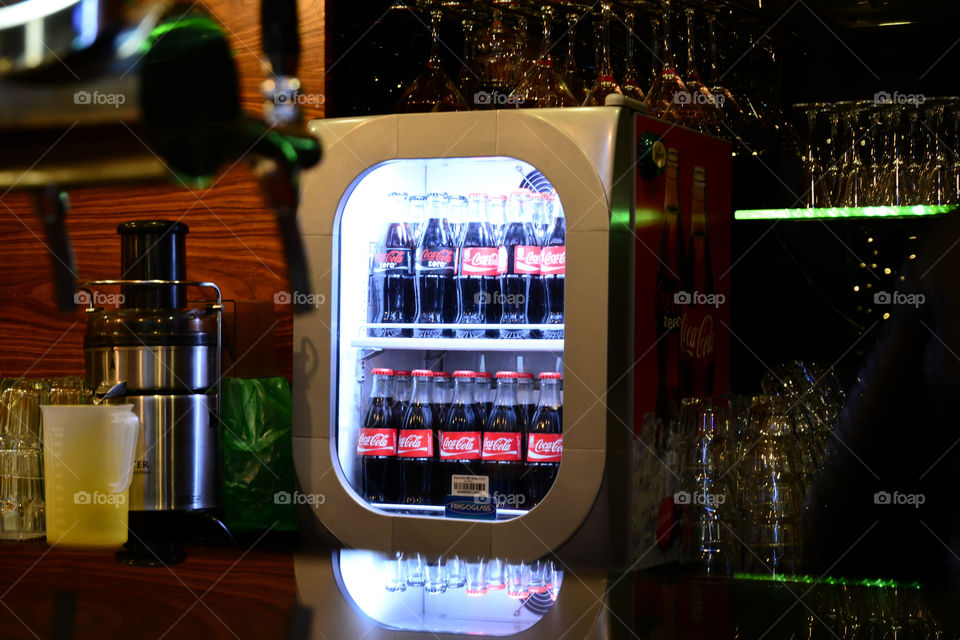 coca-cola bottles in the fridge with glass window