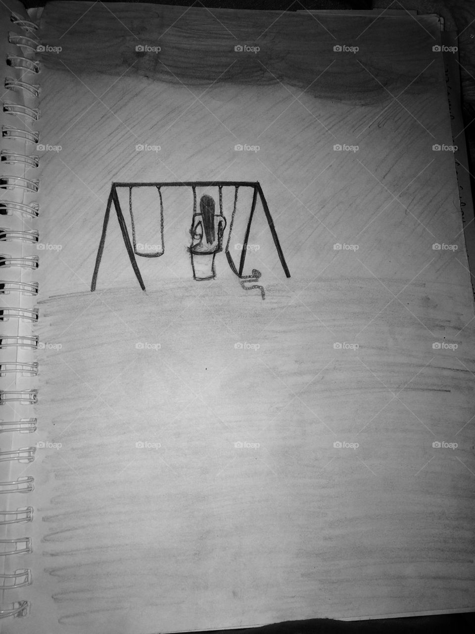 A sad girl swinging in the rain