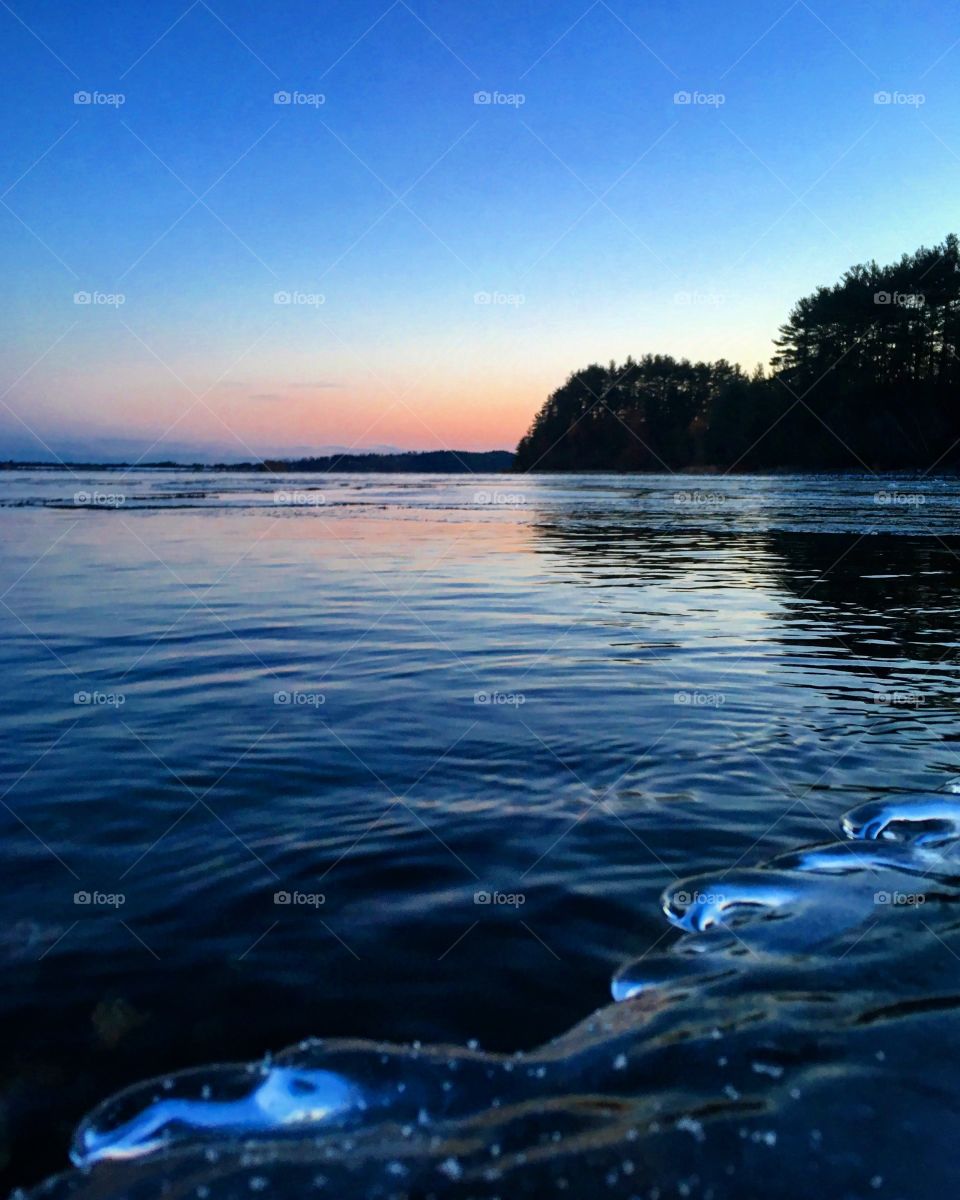 Sunrise on the frozen lake shore