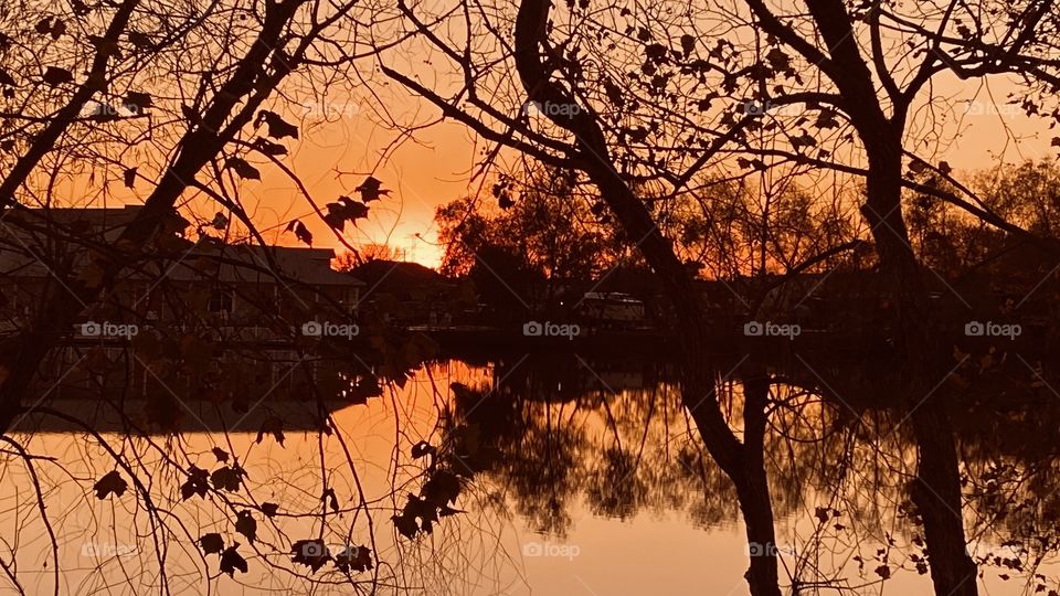 Setting Sun Colors appearing reflections. Shadows from landscapes. Fall foliage still bearing on trees. 