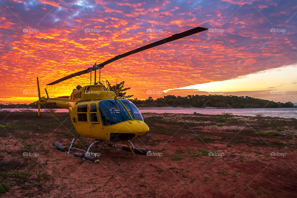 Sunset in Torres strait, North Queensland Australia, helicopter on the land
