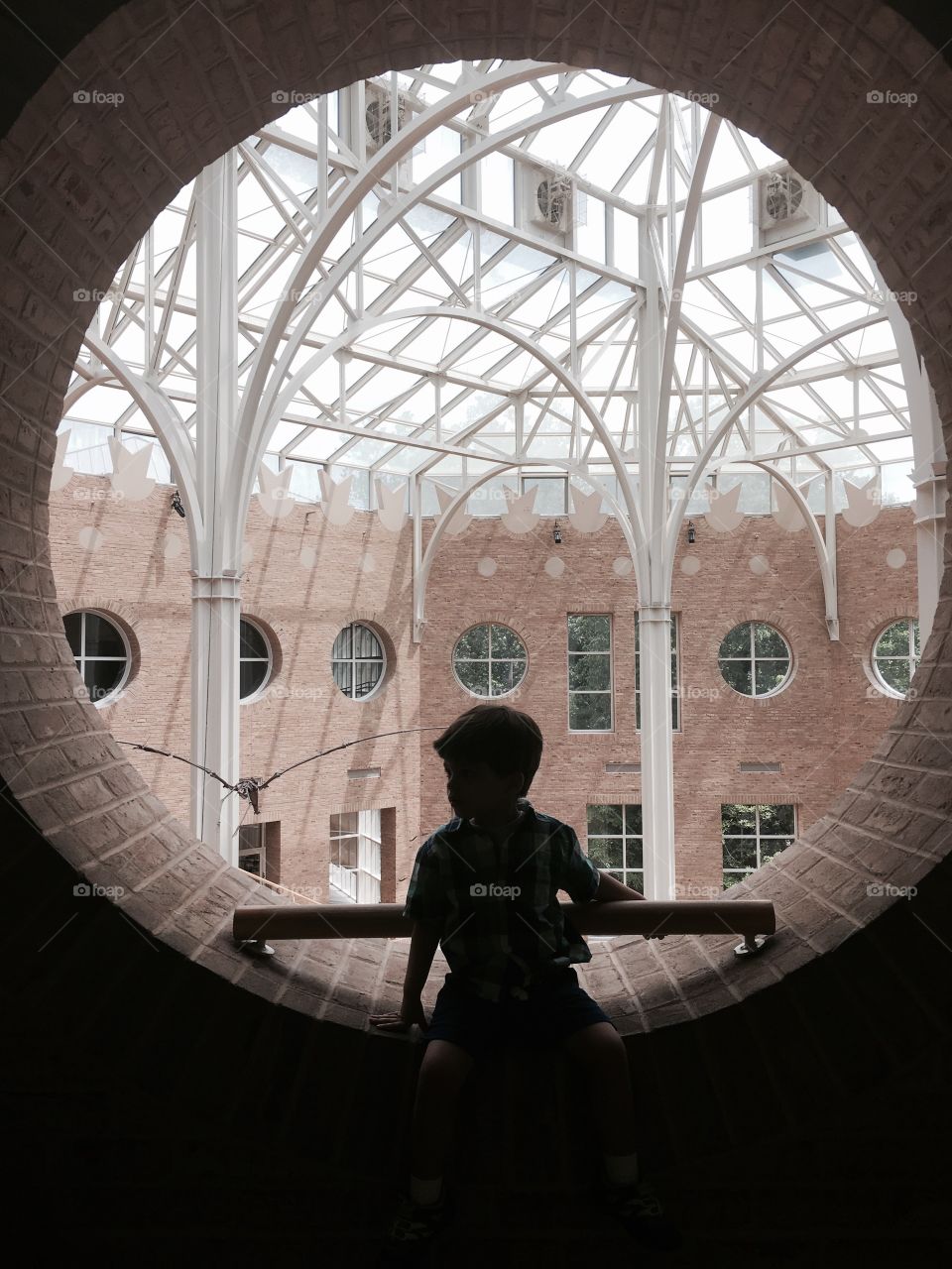 Child silhouetted against architecture.
