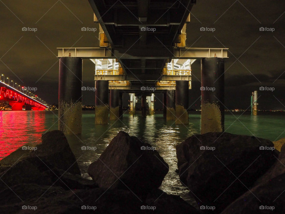 Taking an evening stroll by the water and exploring under the pier on a calm and clear night