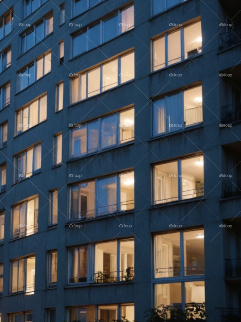 Looking the twinkling  windows of a building