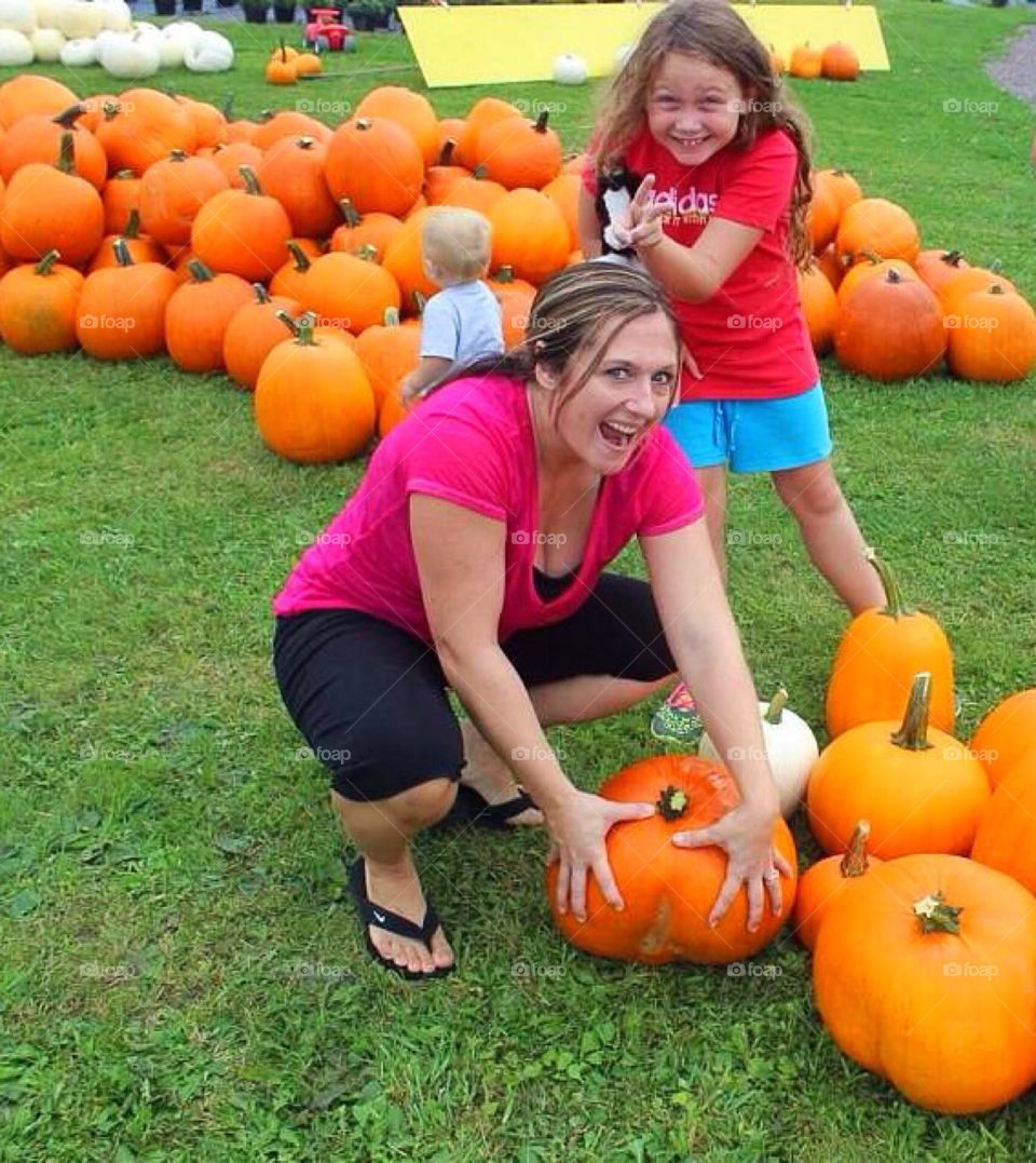 Mother and daughter in pumpkin patch