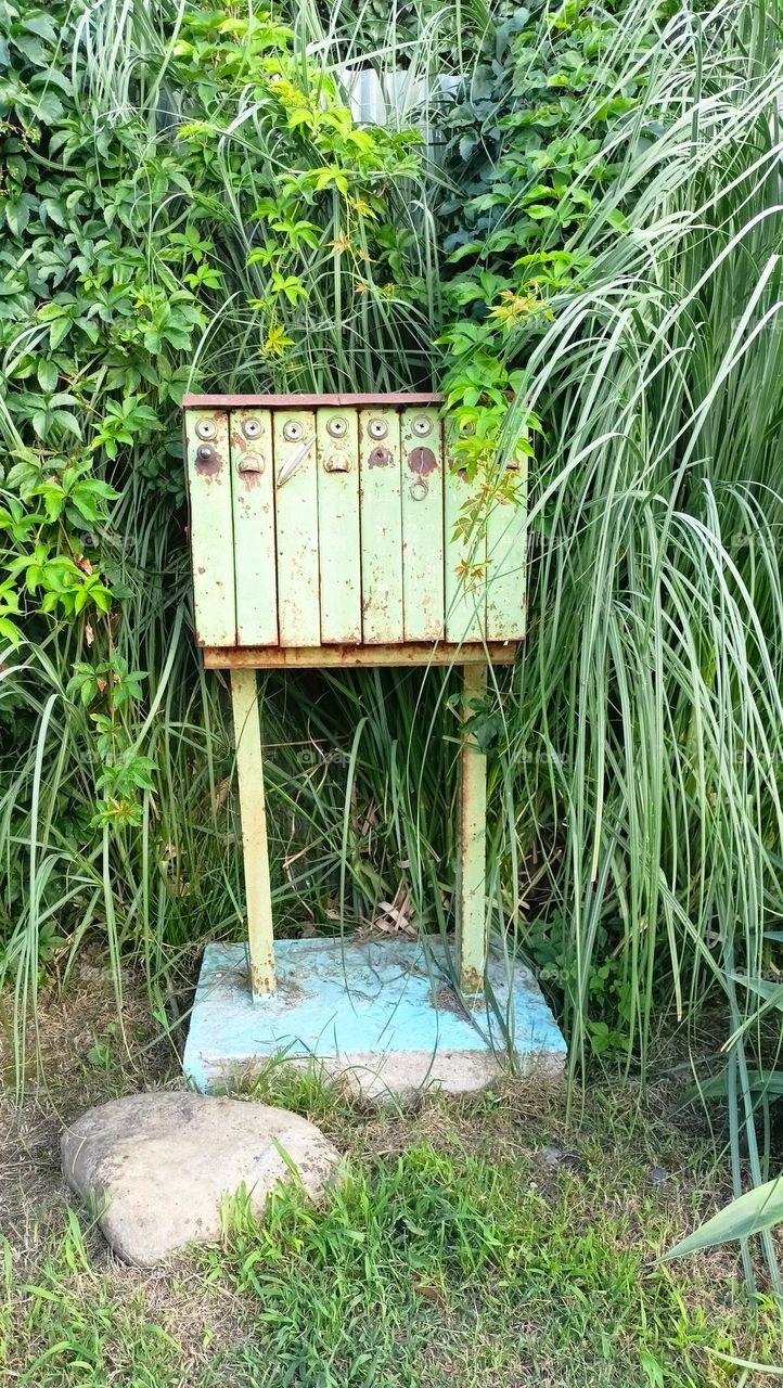 old mailbox, rusty mailbox, mailbox on the street, green grass, warm and sunny