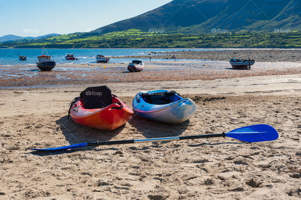 Kayaks on the beach. Low tides on sea.