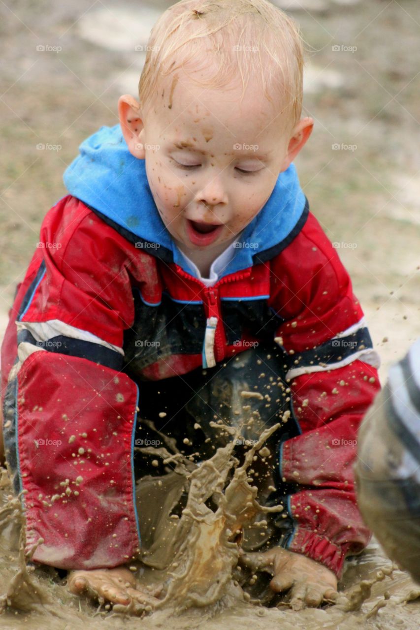 Boy playing in mud