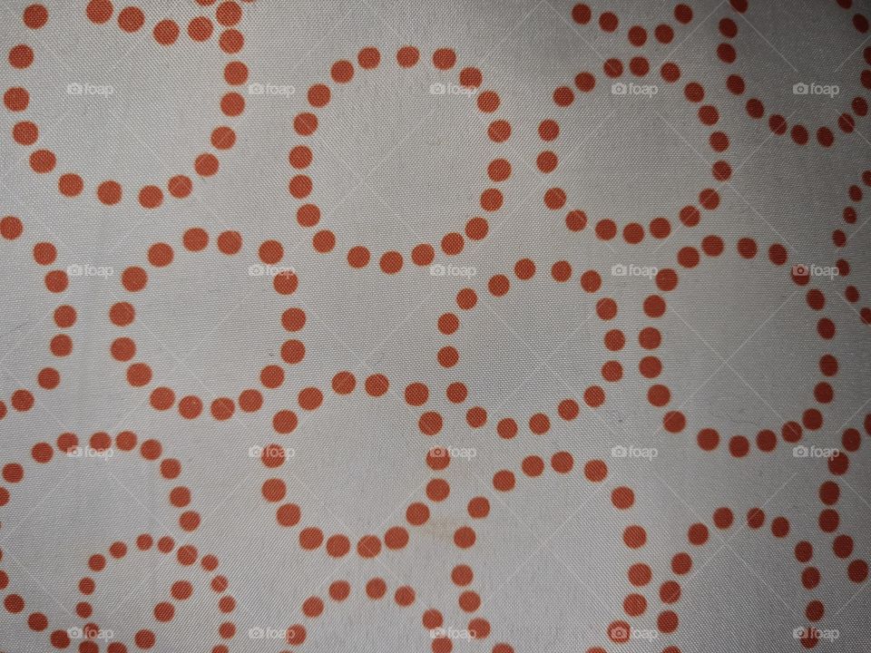 Pillow's fabric pattern. Textile texture with orange dot circles on white background.