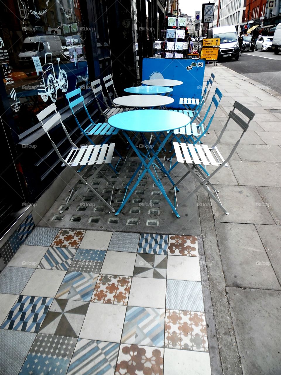 decorative tiles on the street outside a cafe