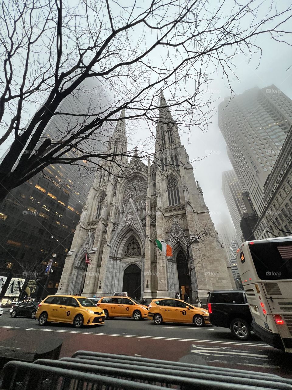 Yellow taxis passing in front of St. Patrick’s Cathedral on a foggy St. Patrick’s Day 2022