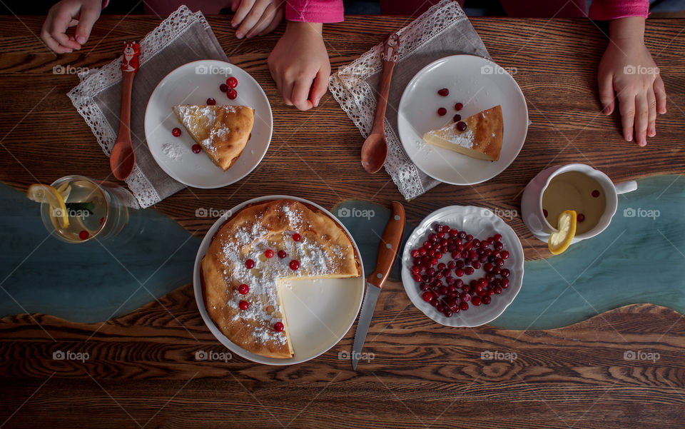 Children breakfast with cheesecake. Hands, detail