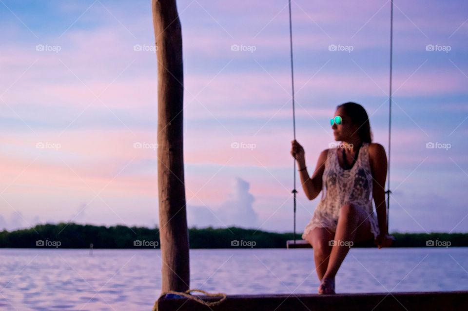 Woman on swing at sea side