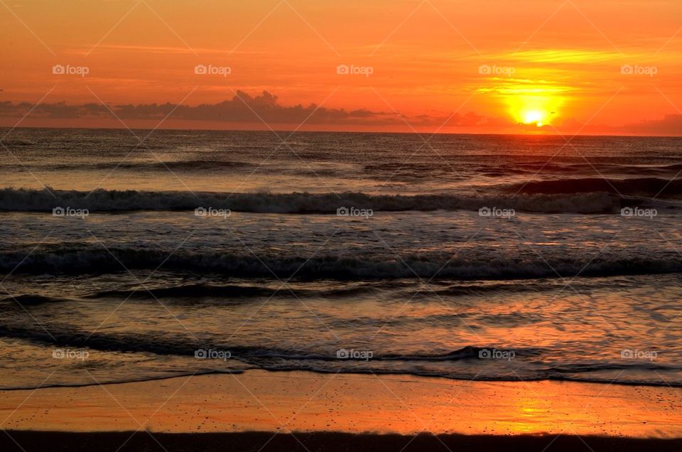 Dramatic sky reflected on beach