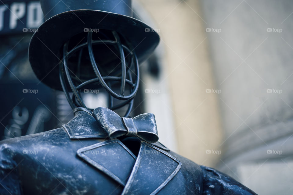 close up view of sculpture of an elegant man in a bow