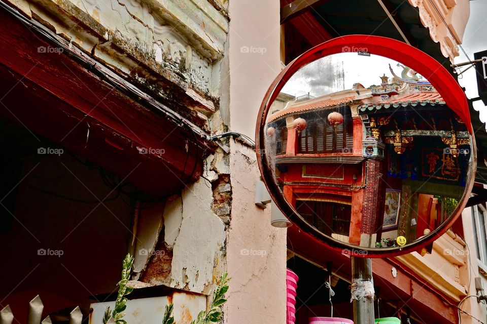 Photo of a ancient Chinese temple reflected in street mirror.
In Penang Chinese culture is very diffuse.
