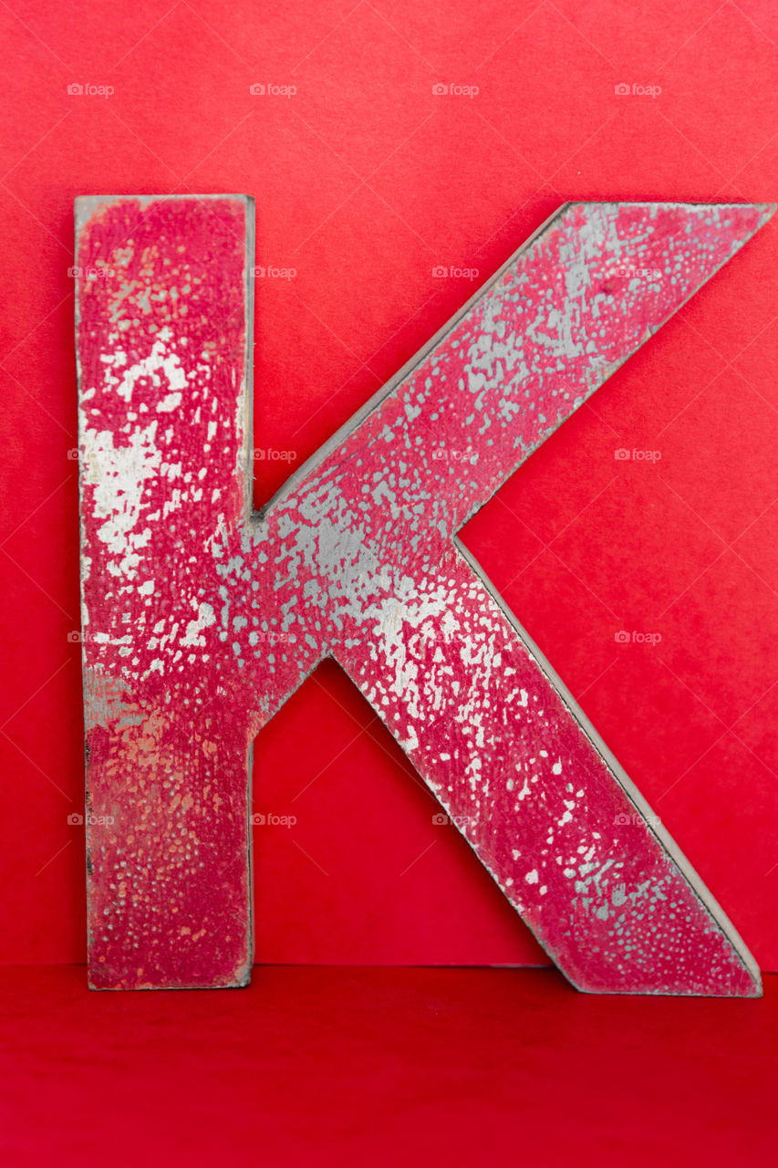 monochrome photography in red: letter K