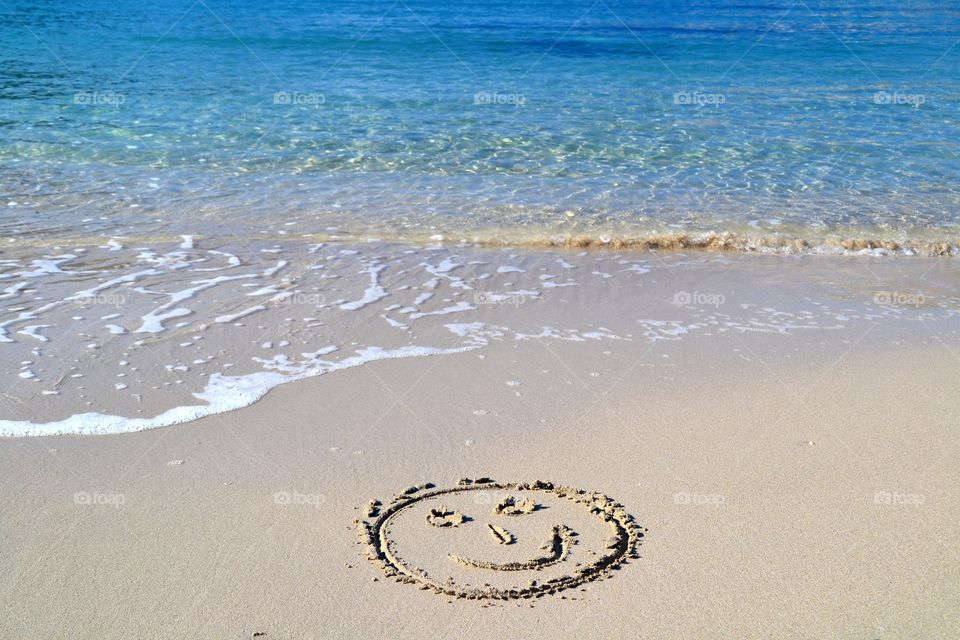 Smile face written in the sand. Smile face written in the sand in the beach of Cala Vadella in Ibiza, Spain