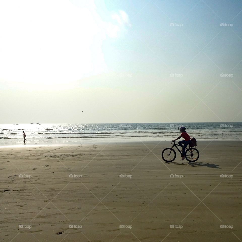 blue sky..sea and riding a bike on the beach...it's all about summer