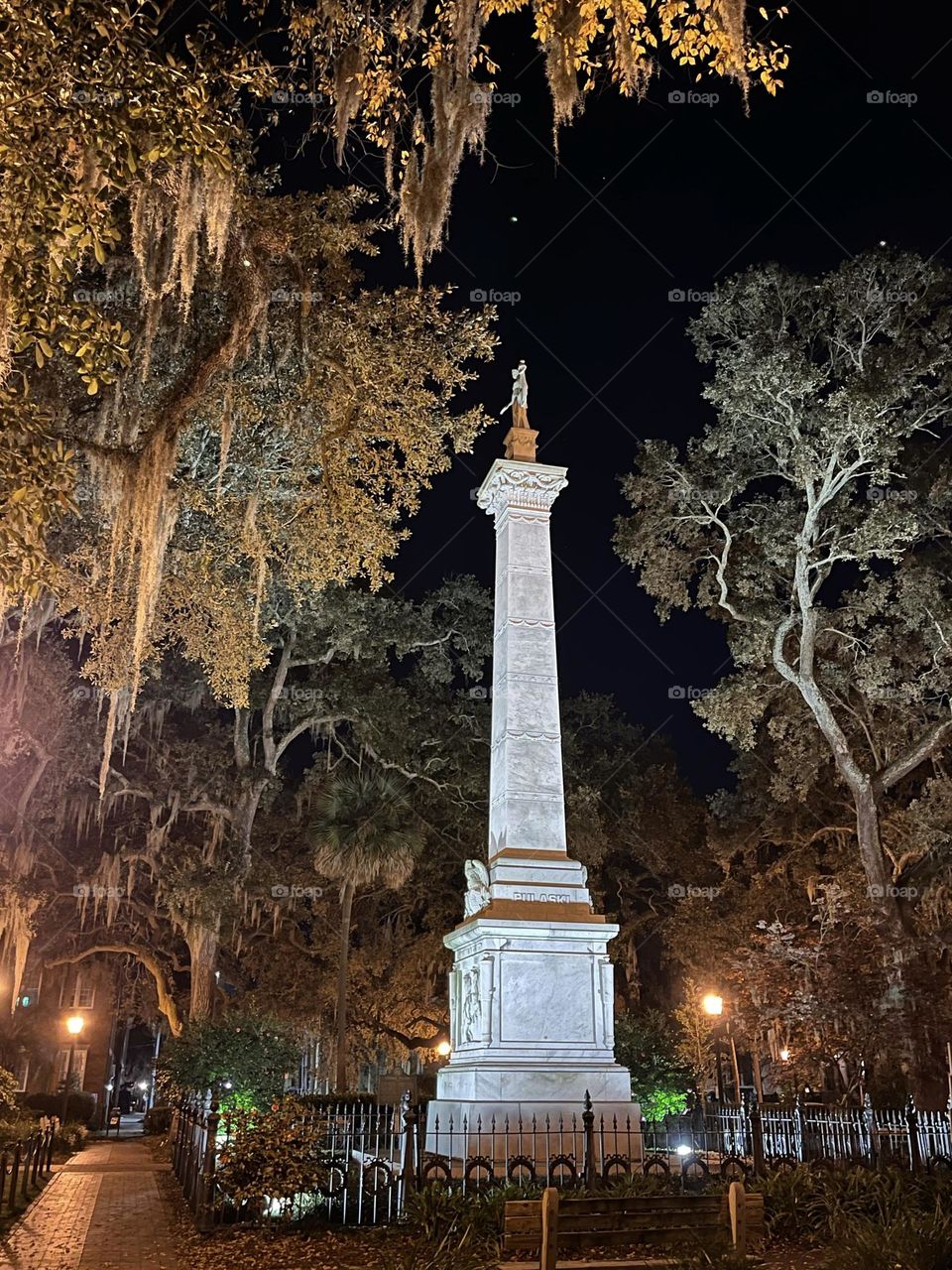 Savannah statue as seen on a ghost tour, surrounded by spooky Spanish moss and historic hauntings 