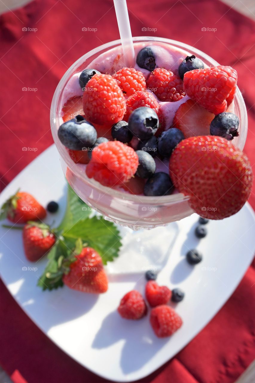 Elevated view of berries on glass