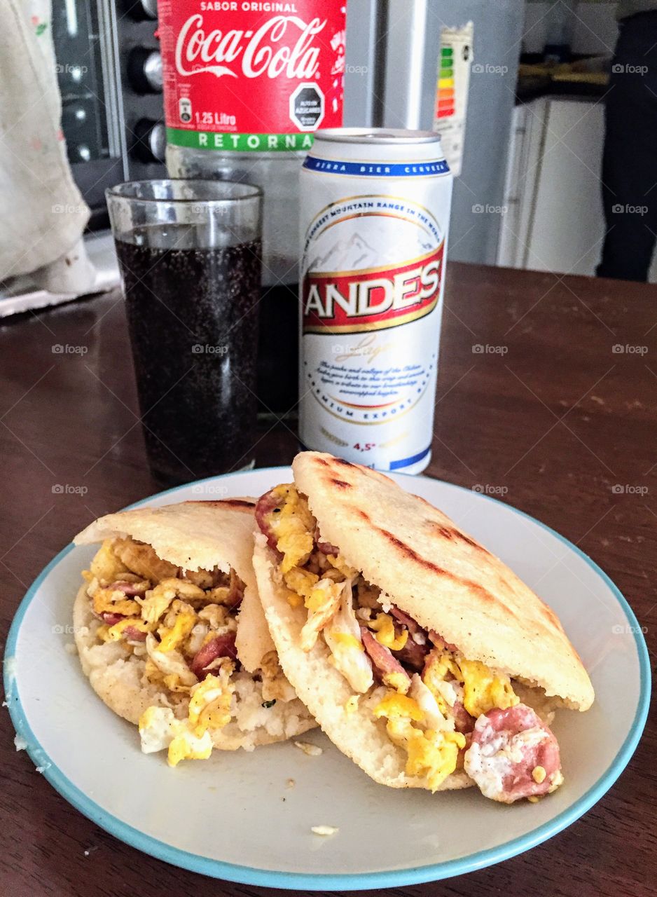 Arepas with eggs and sausages. Venezuelan food.